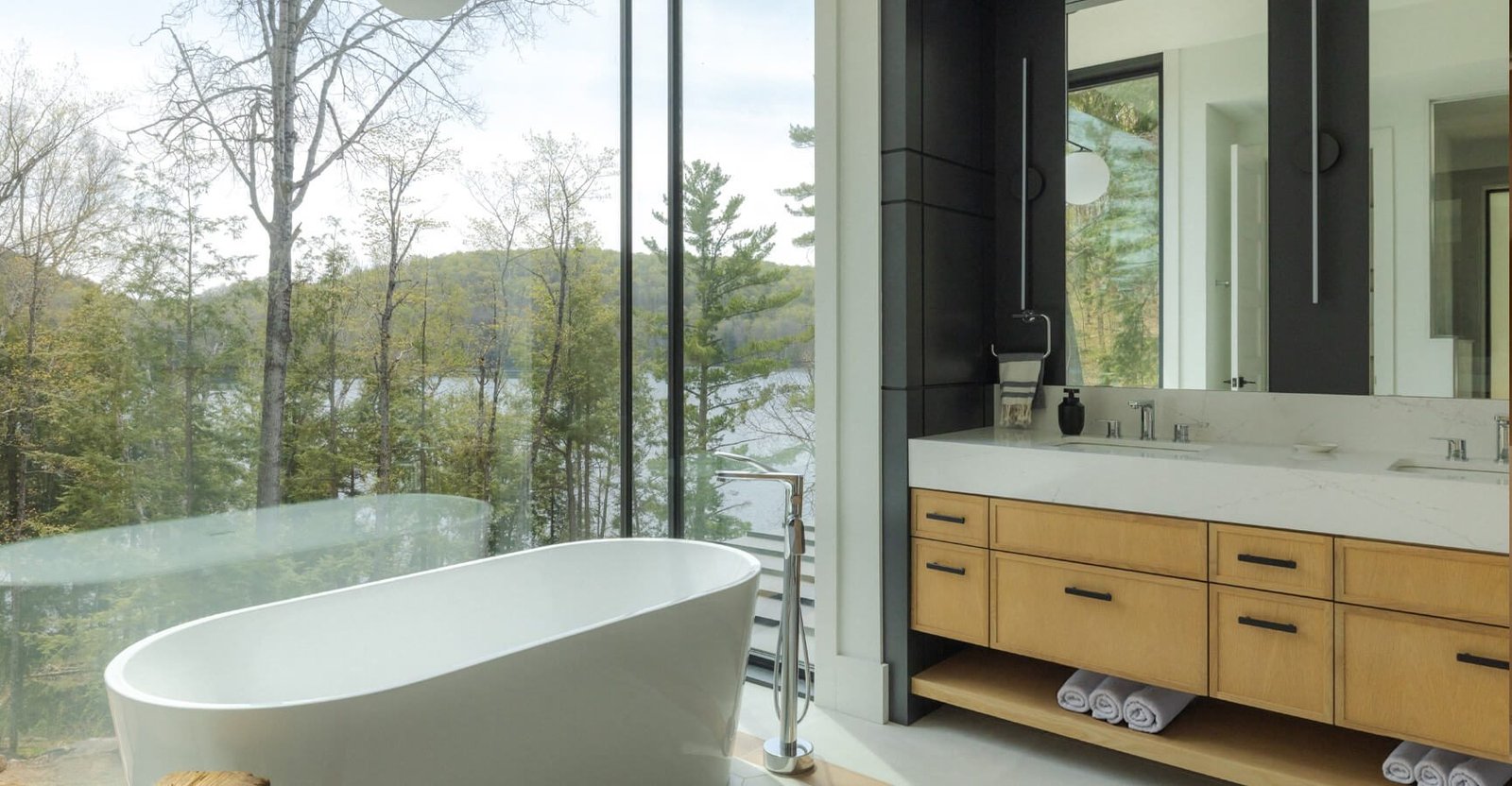 Freestanding bathtub with a floor-to-ceiling lake view at The Crag