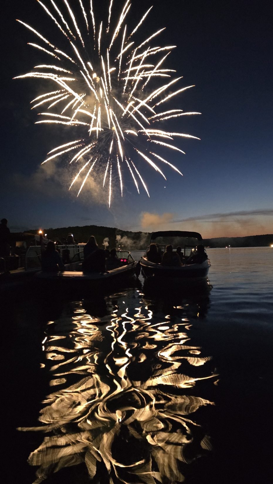 Fireworks over the lake reflected in the water