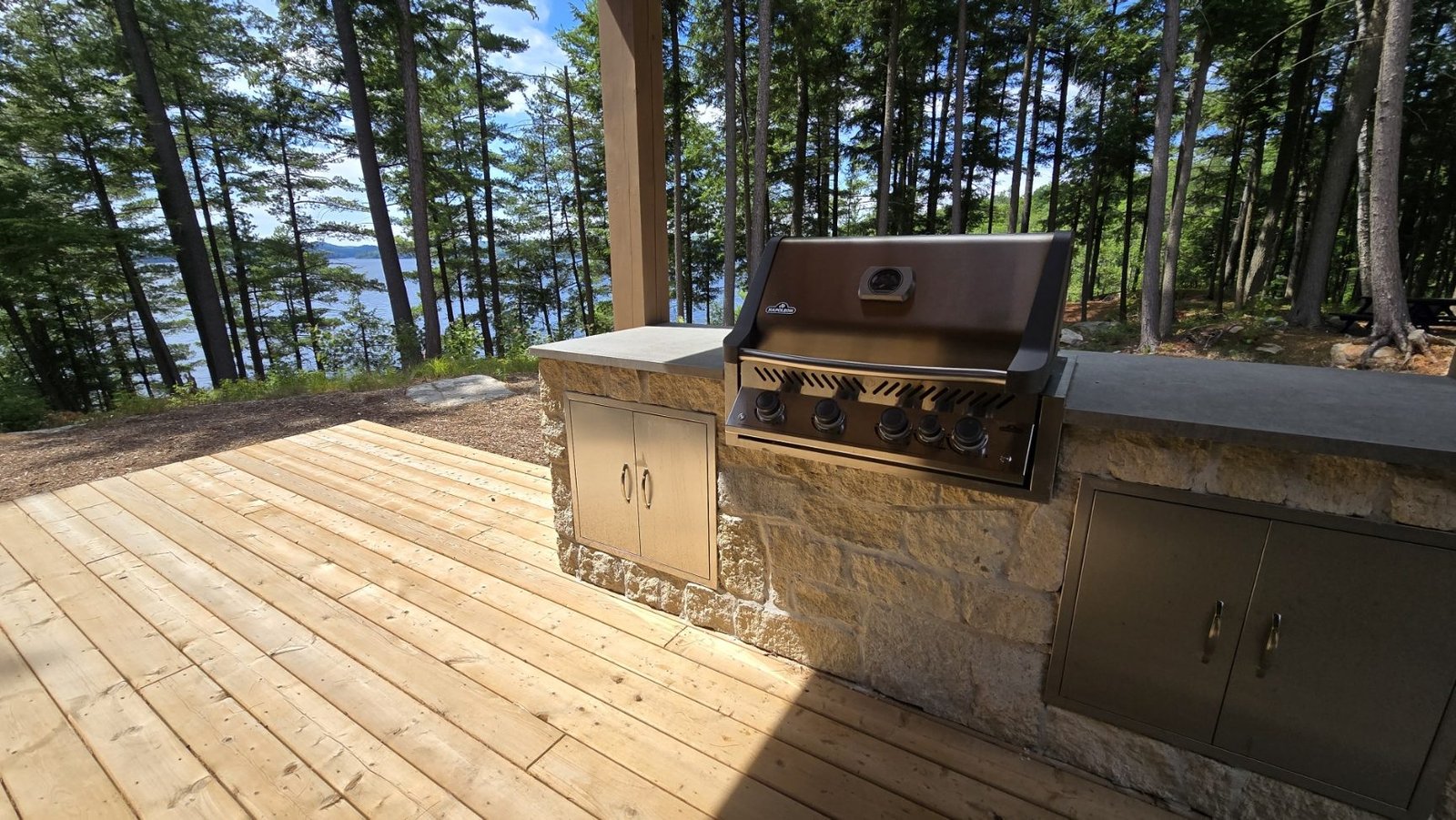 Outdoor stone BBQ kitchen overlooking Haliburton Lake